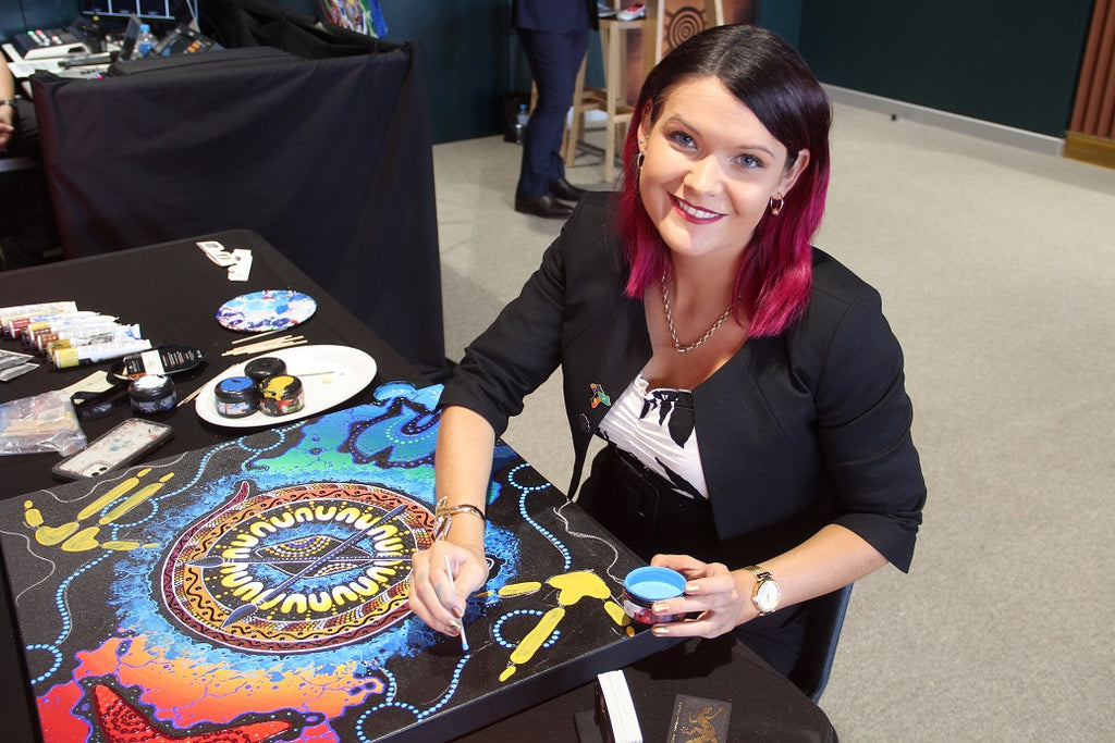 Chern'ee creates artwork in the VIP Corporate box
